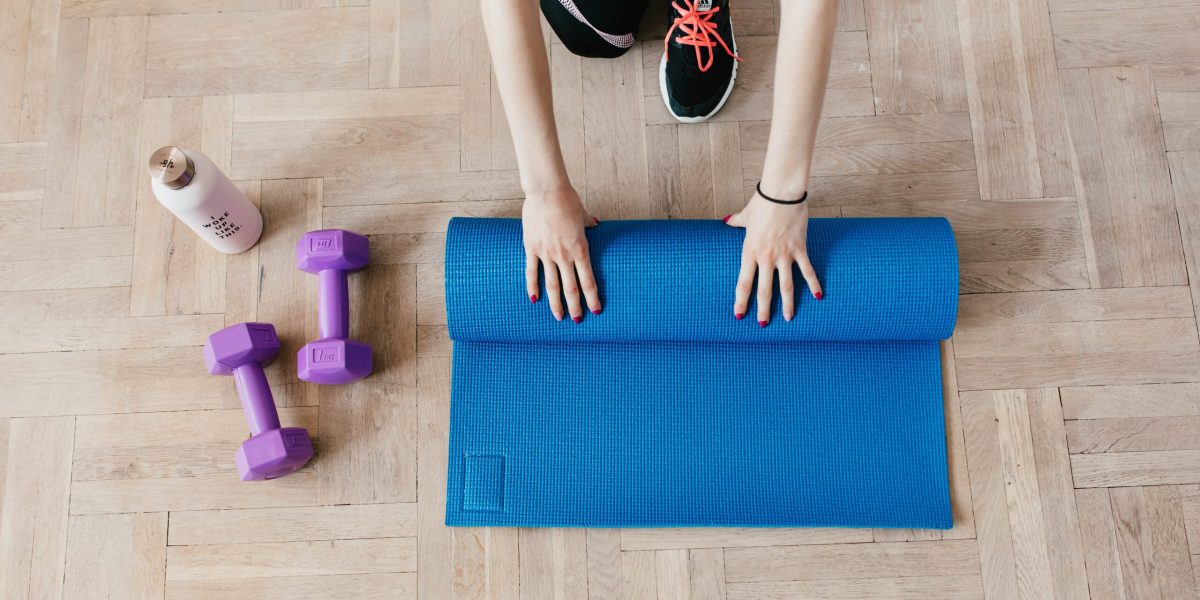 A person rolls up a yoga mat