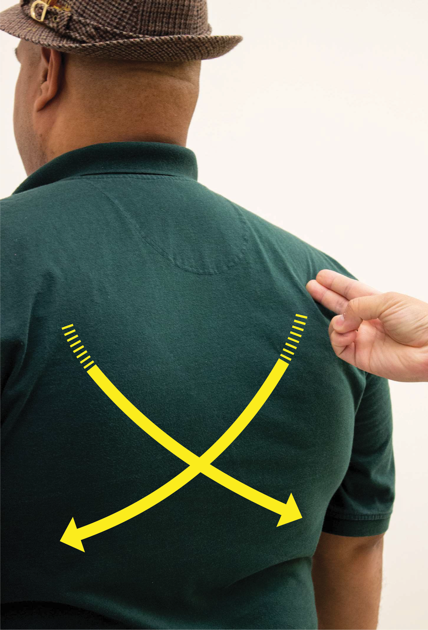 A person demonstrates drawing an “X” on someone’s back – the universal sign for an emergency.