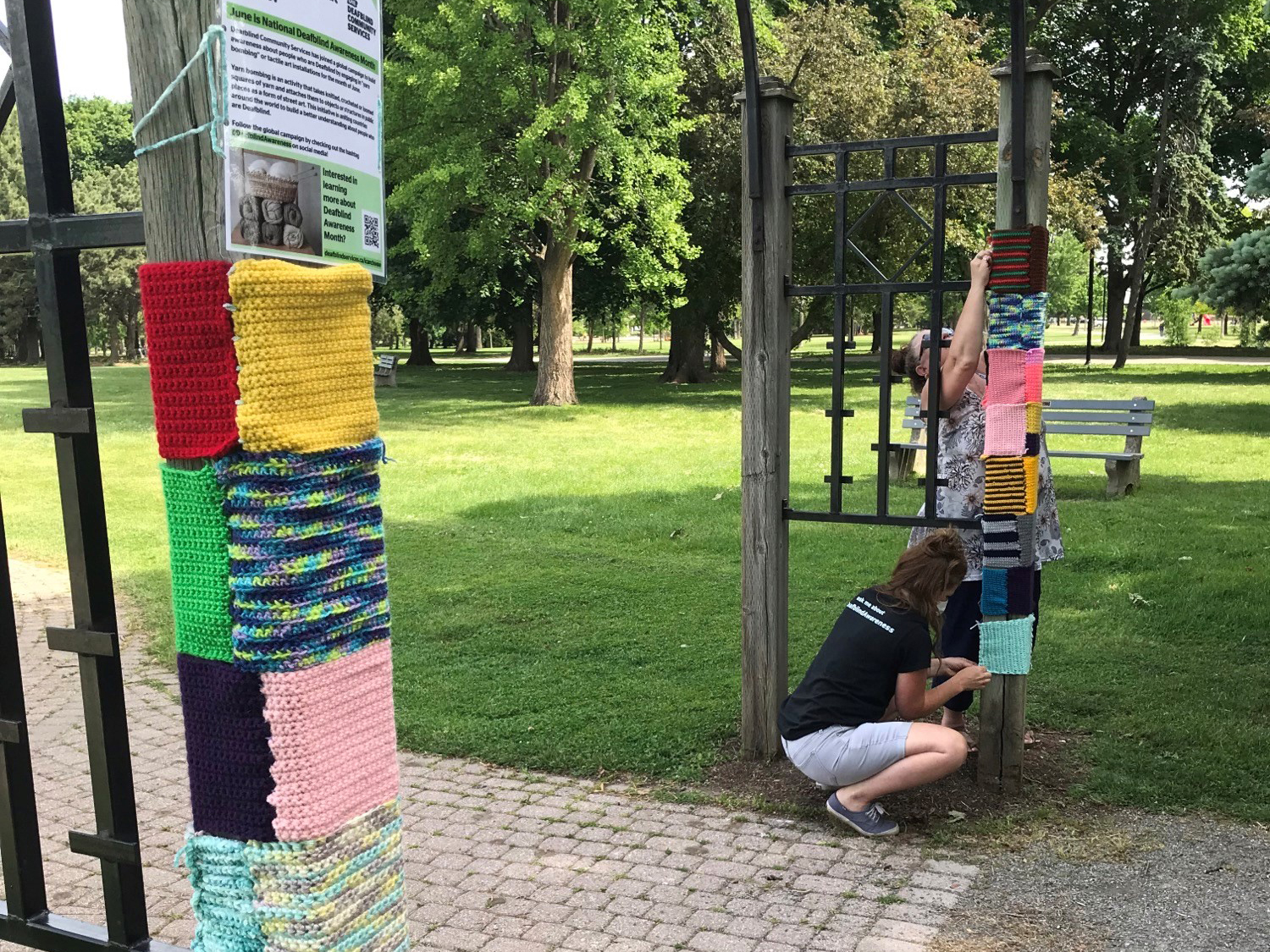 Multicolured yarn is wrapped around an outdoor post in Hamilton.