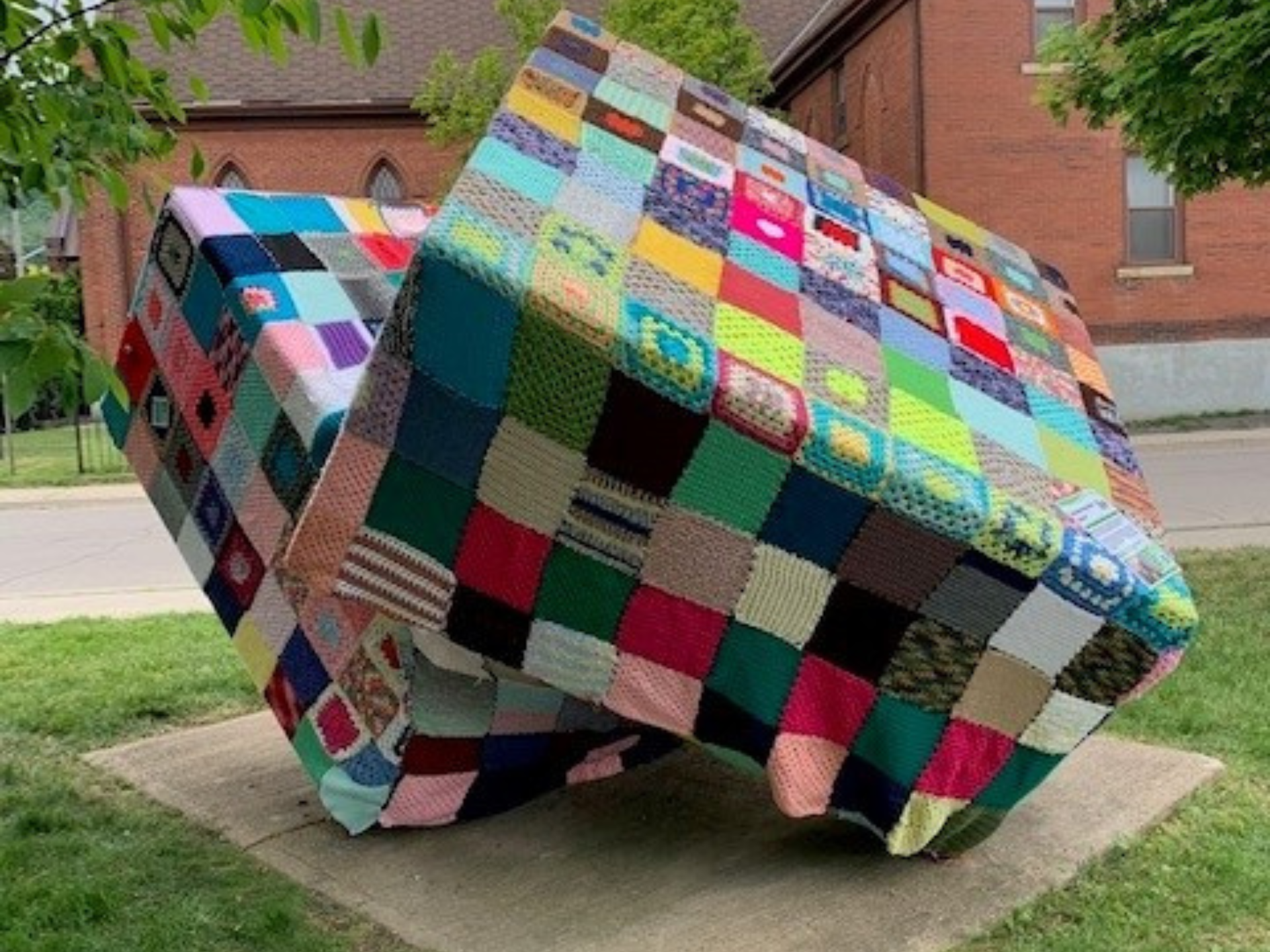 A cube sculpture in Grimsby Ontario that has been covered in yarn 