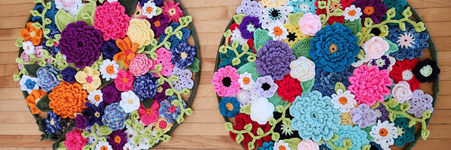 colourful Crocheted flowers arranged in two circles on the floor.
