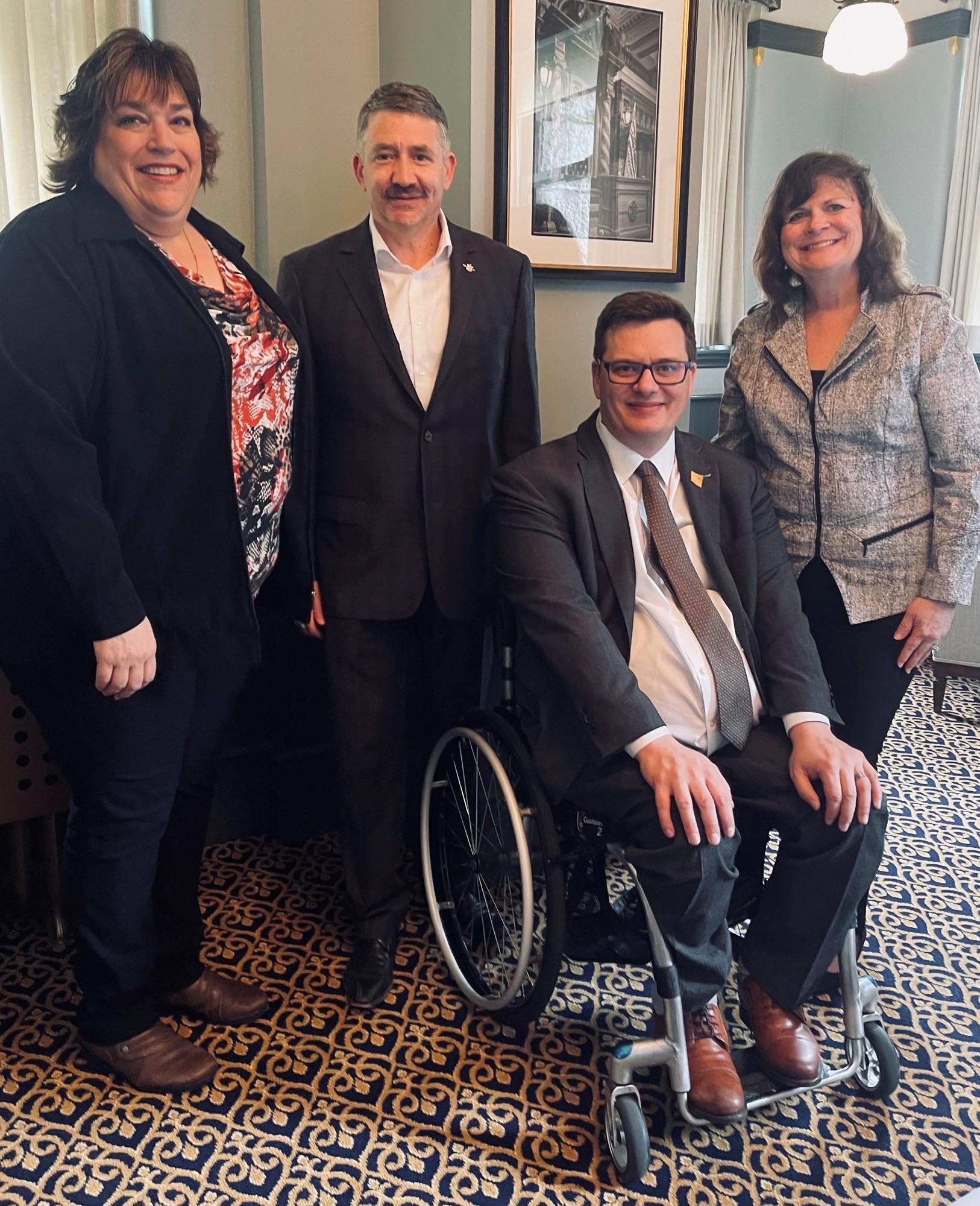 Sherry Grabowski, Vice President of CNIB Deafblind Community services poses with Dan Coulter, MLA for Chilliwack and Parliamentary Secretary for Accessibility, Nicholas Simons, MLA for Powell River-Sunshine Coast and Theresa Tancock, Family Services Coordinator, British Columbia Chapter of the Canadian Deafblind Association.