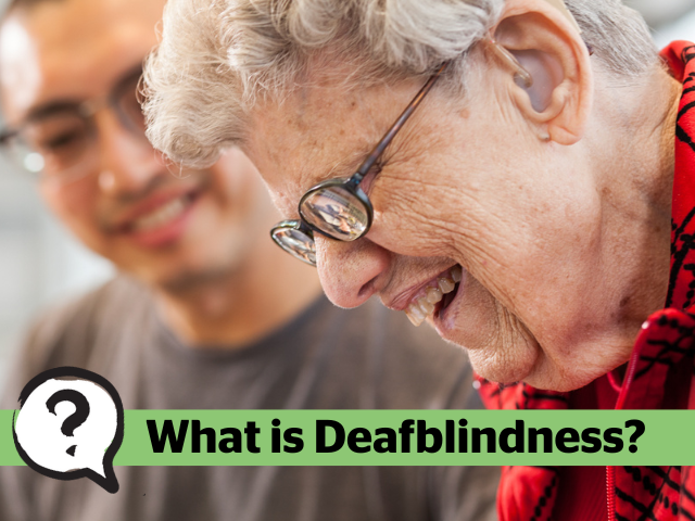 A woman wearing hearing aids and glasses has a big smile. The text, What is Deafblindness?